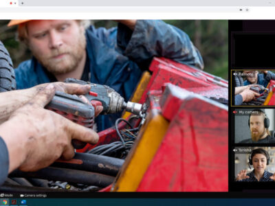 Workers performing remote maintenance on forestry equipment in the field